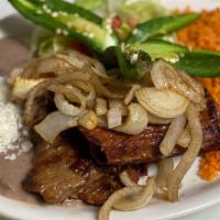 Carne Asada · Carne asada served with grilled onions, jalapeños, and tomatoes. Served with guacamole salad...