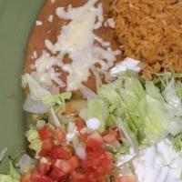 Enchiladas Verdes · 3 enchiladas topped with green sauce and cheese. Served with rice, beans, lettuce, tomatoes,...