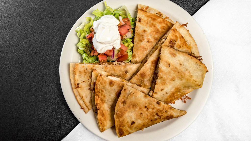Quesadillas · A flour tortilla folded in half with melted cheddar jack cheese served with salsa and sour cream.