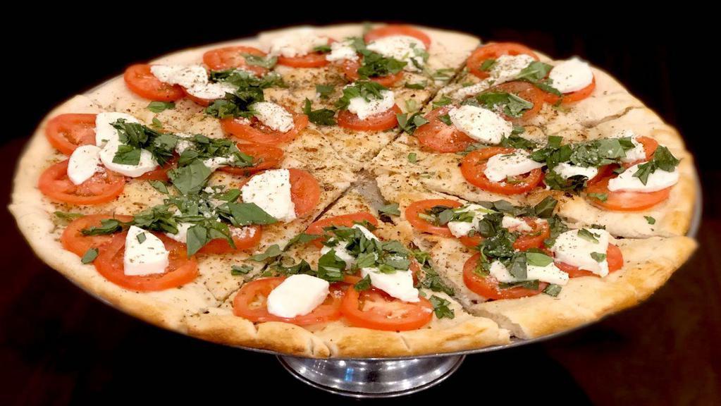 Caprese Pizza · Fresh mozzarella, fresh sliced tomatoes & basil leaves.