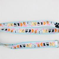 Doggo Lanyard · Lanyard filled with cute Shiba Inu dogs and little flowers. There are red shibas, white shib...