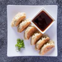Pork Gyoza Dumpling · Six pieces. Cabbage, wheat gluten, white onion, garlic, chives served with Japanese seasonin...