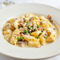 Tortellini Alla Crema · Choice of cheese or meat tortellini in a cream sauce with pancetta, mushrooms, and peas.