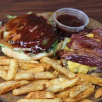 Texas Burger · Served with Cheddar Cheese, Bacon, lettuce, tomato, grilled onion, and BBQ Sauce.