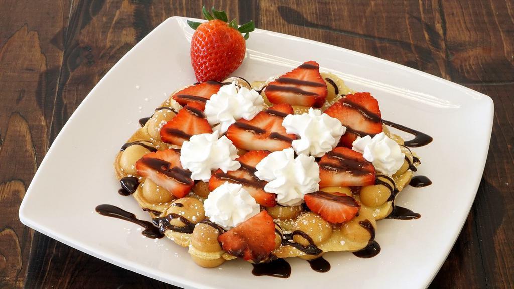Strawberry Whip · Bubble Waffle, sprinkled powder sugar, fresh strawberry, chocolate drizzle and whip cream.