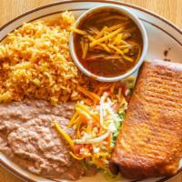 Chimichanga Dinner · A deep-fried burrito filled with chicken, beef, or pork. Topped with chili con carne and shr...