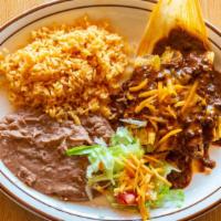 Tamale Dinner · Three pork tamales topped with our chili con carne and shredded Cheddar cheese. Served with ...
