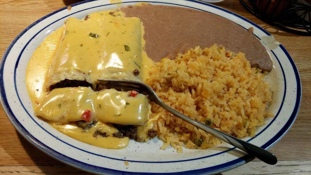 Texas Enchilada Dinner · Two enchiladas with chicken, beef, or cheese. Topped with our Texas sour cream sauce. Served with rice and beans. Small salad garnish included.