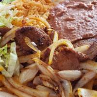 Carne Asada Dinner · Steak meat cooked on the grill with onions. Served with small garnish salad, rice beans, and...