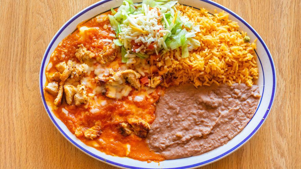 Saltillo Dinner · A full chicken breast cooked with our special seasoning on the grill. Topped with our fresh ranchero sauce and shredded Swiss cheese. Served with rice, beans, and a small garnish salad.