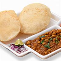 Chole Bhature. · Spicy tangy chickpeas gravy served with fried puffy breads.