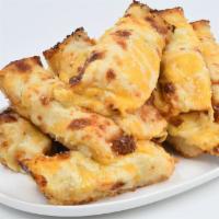 Triple Cheesy Sticks · Breadsticks, topped with three cheese, cheddar and butter garlic parmesan. With sauce on the...