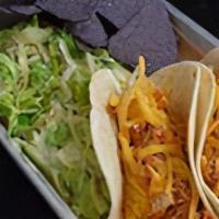 Kid Taco · Two Chicken Tinga and cheddar cheese tacos on a flour tortilla

Kids meals include option of...