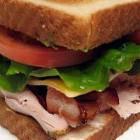 Turkey And Avocado Sandwich · Cheese, mayo, mustard, lettuce, tomato, and pickle