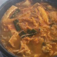 Kimchi Jjigae · Spicy kimchi soup boiled in a stonebowl with tofu, pork, green onion, mushroom. Served with ...