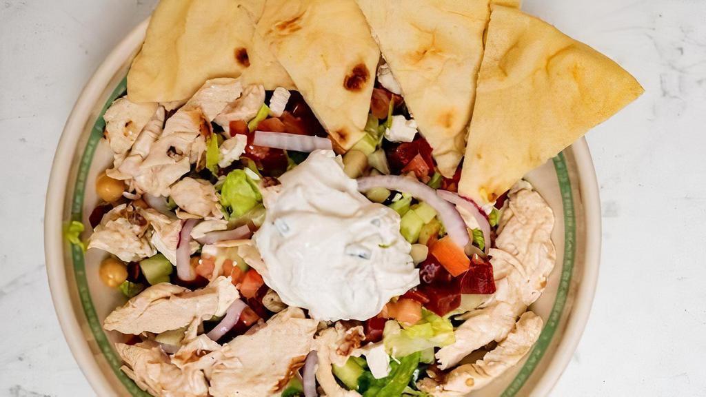 Chicken Gyro Greek Salad · Classic Greek salad with feta, chickpeas and shredded beets, topped with chicken gyro and tzatziki. Served with toasted Naan bread.