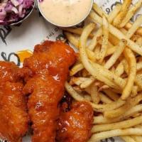 Tenders Buffalo · Three crispy tenders tossed in buffalo sauce with fries, house-made slaw and buttermilk ranc...