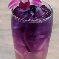 Passion Fruit Lemonade · Passion fruit lemonade topped with butterfly pea flower tea.