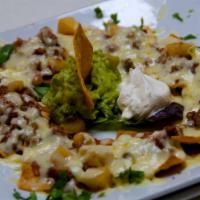 Nachos · Tortilla chips, beans & chihuahua cheese. Served with guacamole & sour cream.