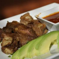 Carnitas De Puerco · Tender fried pork, avocado slices served with a chipotle salsa. Spanish rice, frijoles, and ...