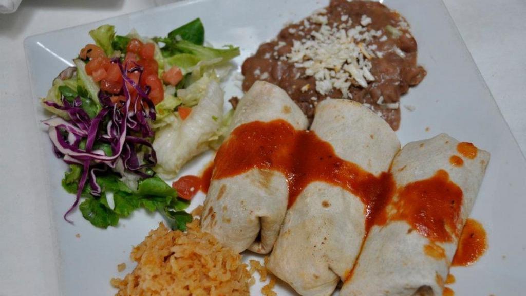 Burritos · Three flour tortilla burritos with beans nestled in ranchera salsa.