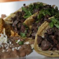 Steak Tacos · Served with cilantro and onions.