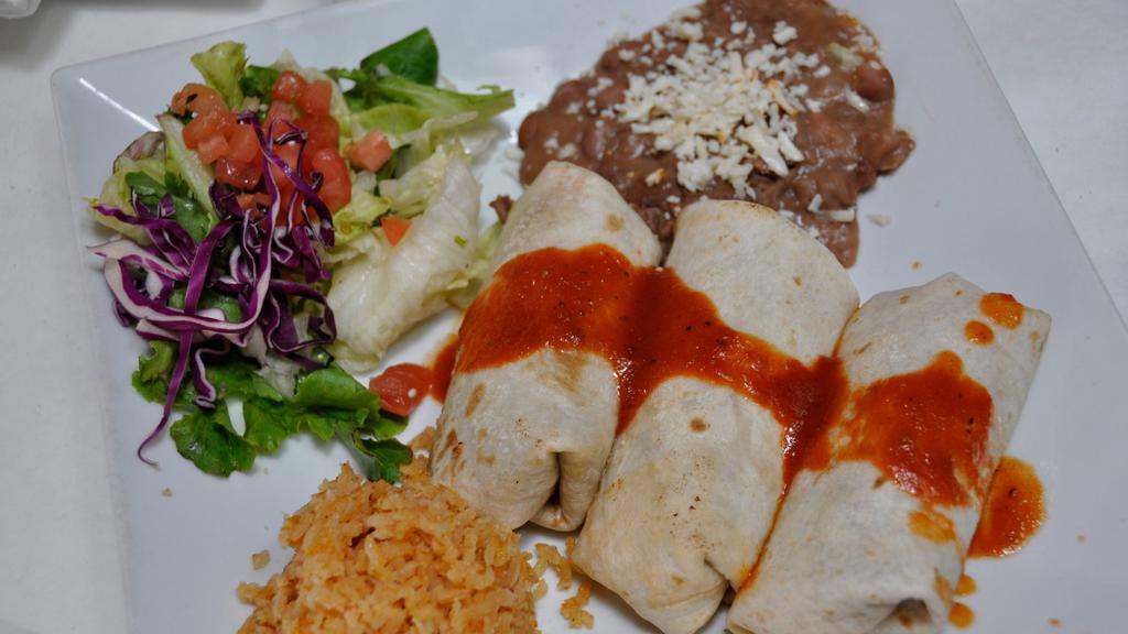 Chimichangas · Three soft flour tortillas stuffed with beans, and your choice of filling deep fried and topped with tomatillo salsa.