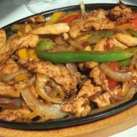 Vegan Fajitas · Soy protein strips, red, yellow, green peppers, tomatoes, onions, garlic, served in a sizzli...