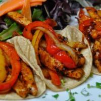 Vegan Tacos · 3 Corn tortillas filled with vegan protein strips, red & yellow peppers. Spring mix. White r...