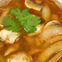 Tom Yum Soup · Spicy.  Hot and sour soup with Thai herbs,  lime juice,  onions, chili paste,  mushrooms and...