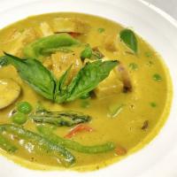 Green Curry · Spicy. Simmered in coconut milk with eggplant, green pea, chili and basil leaves. Spicy.