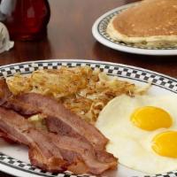 2 Eggs With Bacon · Served with Hash Browns or Fruit. Choice of Toast or Pancakes.