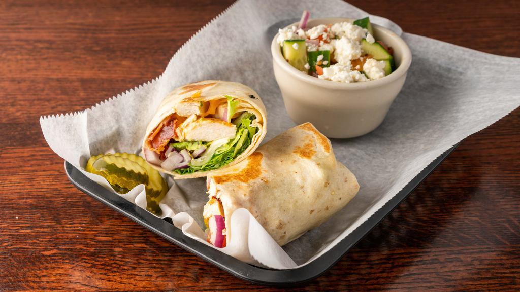 California Wrap · Chicken, avocado, bacon, and Cheddar, with lettuce, tomato, and onion. Served with potato chips. Add any side for an additional charge.