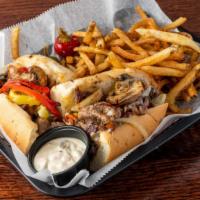 Ribeye Philly Cheesesteak · Shaved Ribeye Steak on a fresh Audinos roll. Topped with your choice of cheese and veggies a...