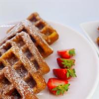 Wings & Waffles · 5 naked wings on top of a waffle drizzled with maple syrup & powdered sugar.