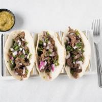 Tacos · Three corn street tacos with your choice of meat, traditional cilantro, and onion or America...