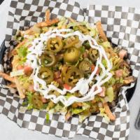 Loaded Fries · Our hand-cut golden fries topped with nacho cheese, shredded Romaine lettuce, diced tomatoes...