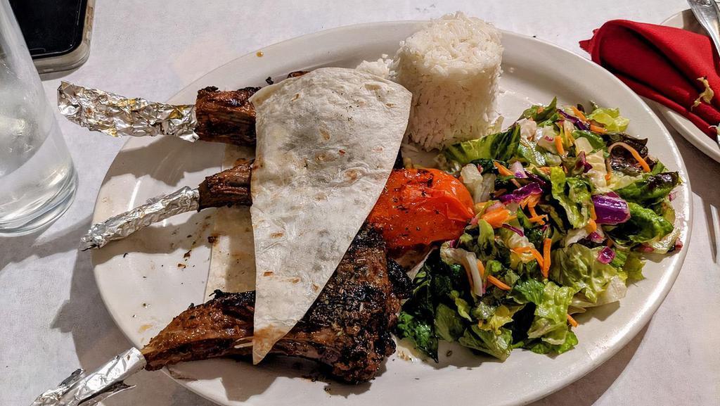 Lamb Chops · Grilled lamb chops with grilled red and green bell peppers and served with Turkish rice and salad.