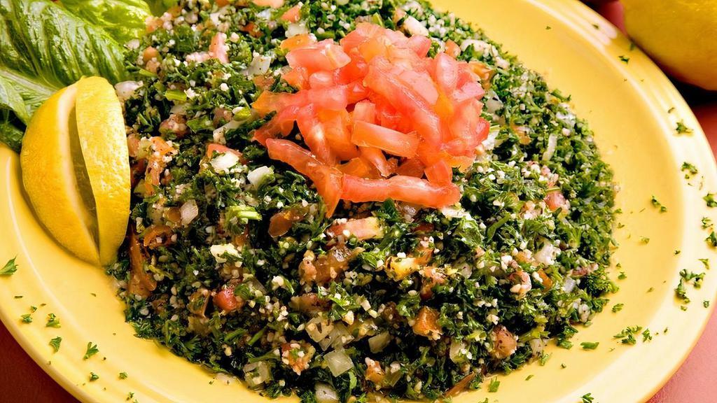 Lg Tabbouli · Vegetarian. A mixture of chopped parsley, onion, tomato, cracked wheat, tossed with extra virgin olive oil & lemon juice.
