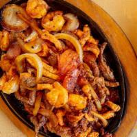 Fajita El Mariachi · Tender strips of marinated chicken breast, beef, shrimp and chorizo, with sautéed onion, bel...