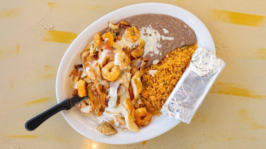 Fajita Caribe · Marinated tender strips of beef, chicken breast, shrimp and pineapple. Served with flour tortillas, lettuce, sour cream, pico de gallo, rice and beans.