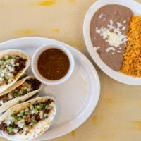 O/ Tacos Carne Azada Or Carnitas · There flour tortillas stuffed with slices of steak. Served with pico de gallo, hot green sal...