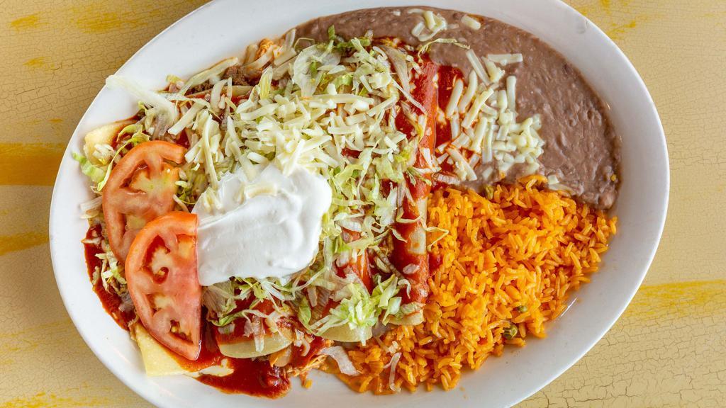 Enchiladas El Mariachi · Four enchiladas, one beef, one cheese, one chicken and one bean, topped with cheese, enchilada sauce, lettuce, tomato and sour cream. Served with rice and beans.