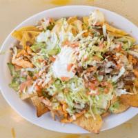 Nachos El Mariachi · Cheese and bean nachos topped with your choice of grilled chicken strips or beef steak, with...