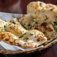 Garlic Naan · Recommended. Chunks of garlic cooked within our famous oven baked flatbread.