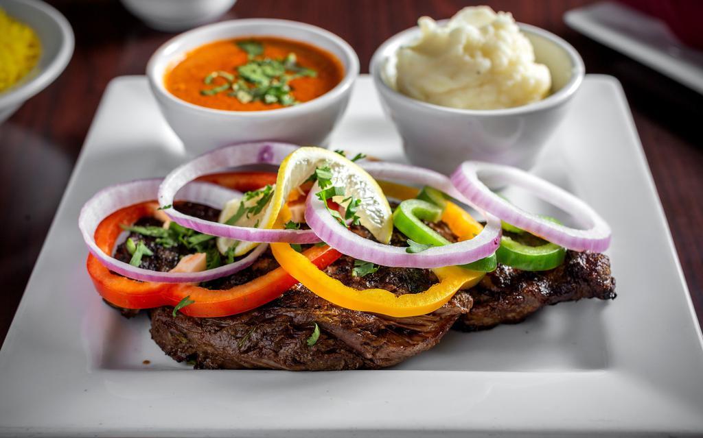 Rib Eye Steak · A juicy cut of rib eye steak marinated and charred any way you like and served with sides of mashed potatoes.