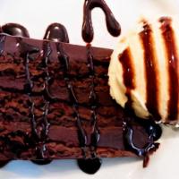 Chocolate Fudge Cake · Decadent fudge cake served with vanilla ice cream and drizzled with hot fudge.