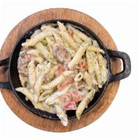 Creamy Pesto Pasta (Individual) · Penne noodle with a creamy basil pesto sauce served with marinated tomatoes and mushrooms.