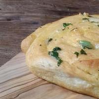 Garlic Bread · Artisan bread brushed with roasted garlic olive oil, Parmesan and mozzarella cheeses, served...
