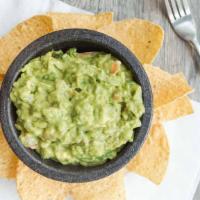 Guacamole & Chips · Vegetarian. Mashed ripe avocado with chopped tomato, onion, cilantro, lime, and chips.
